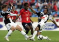 Jean Makoun (c) of Lille, facing Perrier Doumbe (r) of Rennes