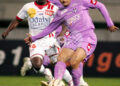 Joel Landry Tsafack Nguemo (L) from Cameroon fights for the ball with Toulouse's Francileudo Dos Santos Silva