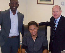 Alex Morfaw (center), with his agent and Iron chairman Steve Wharton, signs for United ahead of the Carling Cup first round clash with Hartlepool United.